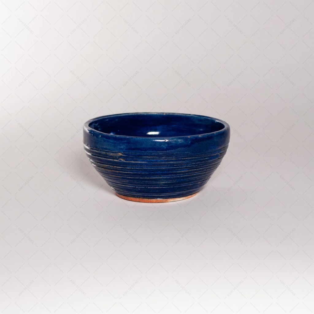 A medium-sized bowl with carved ridges glazed in cobalt blue.