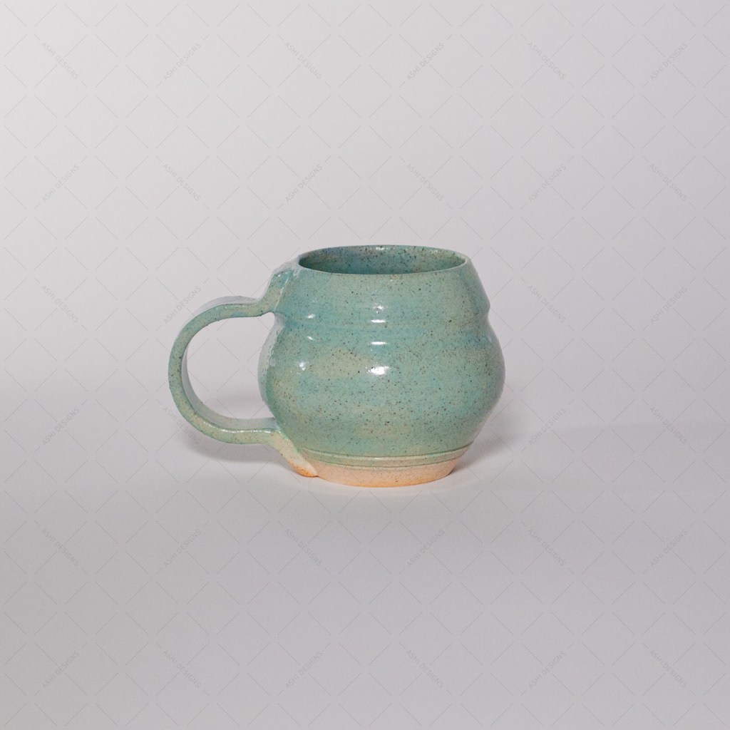 A light celadon green mug with a bulbous shape, like a paper lantern.