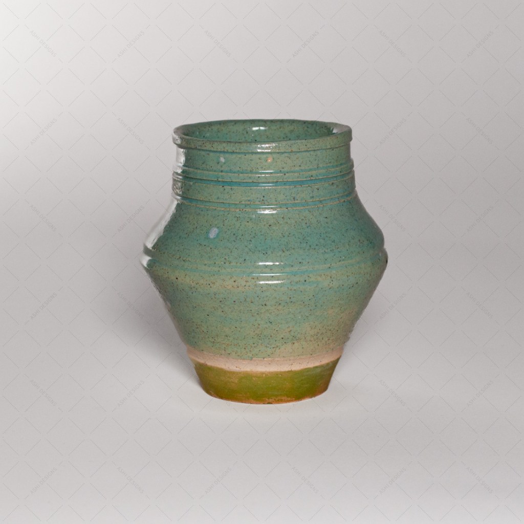 A medium-sized vase with angular sides and carved ridges, glazed in a light celadon green.
