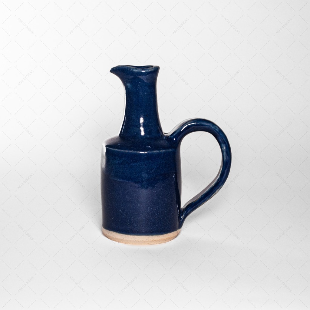 A blue pitcher shaped like a slender bird with a long neck.